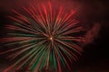 Brilliant red and green fireworks against the backdrop of the night sky Royalty Free Stock Photo