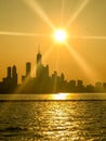 Brilliant sunbeams extend over skyline silhouette of Chicago