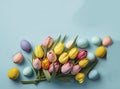 Top view photo of colorful easter eggs and bunches of yellow and pink tulips, light blue, copyspace, generative AI Royalty Free Stock Photo