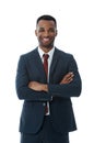 Brimming with confidence. A handsome smiling businessman with his arms folded while isolated on white.