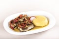 Brine fish plate with vegetables, chili and polenta, placed on white plate Royalty Free Stock Photo