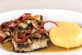 Brine fish plate with vegetables, chili and polenta, placed on white plate Royalty Free Stock Photo
