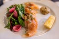 Brined salmon served with salad, pickled onions and mustard