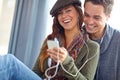 We bring happiness in to each others lives. A close couple listening to music together on a phone and laughing together