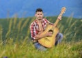 Bring Music to Life. sexy man with guitar in checkered shirt. hipster fashion. western camping and hiking. happy and