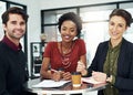 We bring new ideas to the table every day. Cropped portrait of a group of businesspeople meeting around a small table in Royalty Free Stock Photo