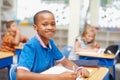 Bring out the best in him with a first-rate education. Handsome young african-american student sitting at his desk in