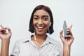 Always bring your best side out. Studio portrait of a young creative businesswoman listening to music on her cellphone Royalty Free Stock Photo