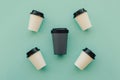 Bring your own cup concept. Reusable eco friendly resistant bamboo cup and many plastic glasses Royalty Free Stock Photo