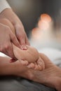 Bringing bliss to her clients. a masseuse giving a client a facial massage. Royalty Free Stock Photo