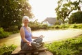 Bringing body, mind and spirit in harmony. Portrait of an attractive mature woman sitting in the lotus position in a