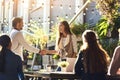 Bringing fresh business expertise to the team. colleagues shaking hands during a meeting at an outdoor cafe.