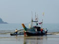 Fishing boat being launched in surf