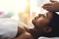 Bringing the mind, body and spirit into alignment. an attractive young woman getting a massage at a spa.