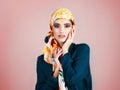 She brings the color out even more. Studio portrait of a confident young woman wearing a colorful head scarf while Royalty Free Stock Photo