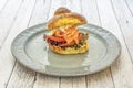 Brioche bread sandwich with smoked salmon, tomato slices, oak lettuce Royalty Free Stock Photo