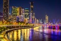 Brisbane, Australia - City illuminated at night with Kurilpa bridge across the river Royalty Free Stock Photo