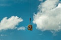 Brisbane, Australia - Construction workers being lifted in a cage by a crane