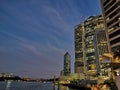 BRISBANE, AUSTRALIA - JULY 10, 2020: Twilight scene of Eagle Street pier in Brisbane River with high-rise residential buildings