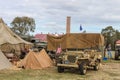 Jeeps carrying bicycles and tents and flags in WW2 reenactment at Living History event