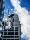 Space Age looking very modern high rise buildings against dramatic blue sky with clouds