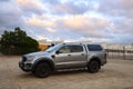 Brisbane QLD Australia: 18 March 2023- Silver Ford Ranger in industrial area with passenger plane flying overhead