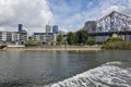 A steel bridge and residential units on the banks of the Brisbane River