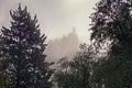 Brisighella, Ravenna, Emilia-Romagna, Italy: landscape on a foggy morning with the ancient tower in the background Royalty Free Stock Photo