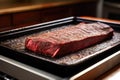brisket probed for temperature on an aluminum tray Royalty Free Stock Photo