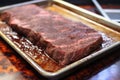 brisket probed for temperature on an aluminum tray Royalty Free Stock Photo