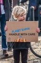 BRISTOL, ENGLAND- 15 January 2022: Toddler with a placard taking part in a Youth Climate Swarm in Bristol