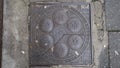 Bristol, UK - February 12 2020: Antique square iron coal hole cover on Clare Street in Bristol