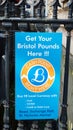 Bristol, UK - February 12 2020: Sign attached to railings advertising a cash point selling the local city currency Bristol Pounds