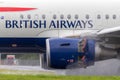 British Airways Airbus A318-112 aircraft G-EUNB landing on the wet runway with reverse thrust spraying water