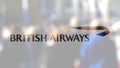 British Airways logo on a glass against blurred crowd on the steet. Editorial 3D rendering