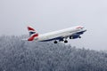 British Airways plane taking in snow, winter in Innsbruck Airport INN