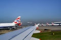 British Airways planes in line on ground in Heathrow Airport. British Airways aircrafts with Union Jack on tail.