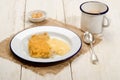 British apple crumble with custard on enamel plate Royalty Free Stock Photo