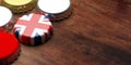 English beers. Beer cap with UK flag on wooden background, copy space. 3d illustration Royalty Free Stock Photo