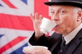 British businessman / city worker with bowler hat drinking tea.