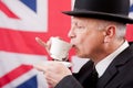 British businessman / city worker with bowler hat drinking tea. Royalty Free Stock Photo
