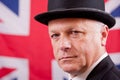 British businessman / city worker with a Union Jack flag background.