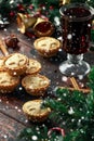 British Christmas mince pies with decoration, gifts, snow, green tree branch on wooden rustic table Royalty Free Stock Photo