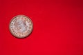 British coin 2 pence 2001 isolated on red background with blurry and space for copy text. Back side of two pence coin. coins