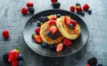 British Crumpets breakfast with blueberries, strawberries, blackberries, raspberries drizzled with icing sugar Royalty Free Stock Photo