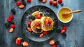 British Crumpets breakfast with blueberries, strawberries, blackberries, raspberries drizzled with icing sugar Royalty Free Stock Photo