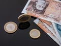 British currency notes and coins on the glass table.