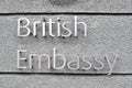 British embassy sign on grey wall