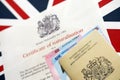 British emergency passport and Certificate of Naturalisation. Yellow color temporary document Royalty Free Stock Photo
