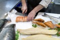 British fish monger slicing, filleting or cutting fresh slamon o